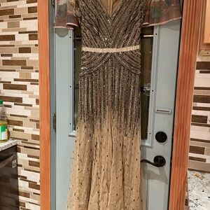 Adrianna Papell .Elegant Sequin Gown with Sheer Sleeves